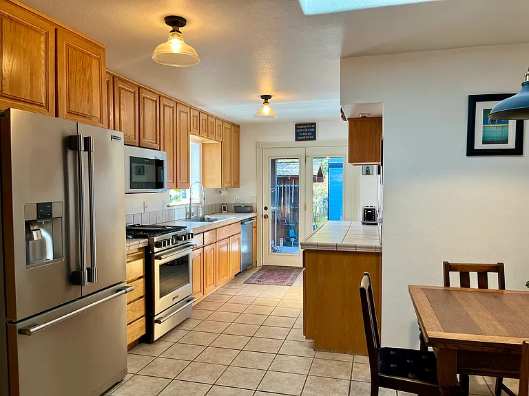 Fully stocked kitchen has plenty of counter space, nice appliances and a skylight