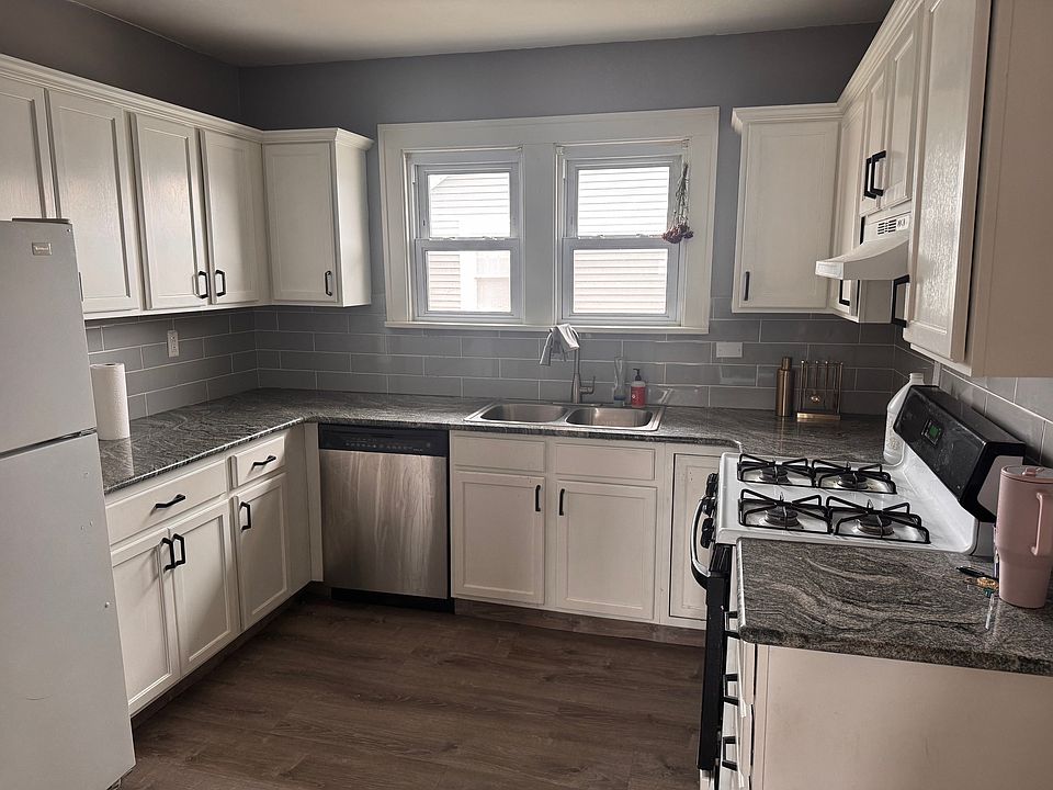 Remodeled Kitchen with granite countertops, tile backsplash, new flooring.