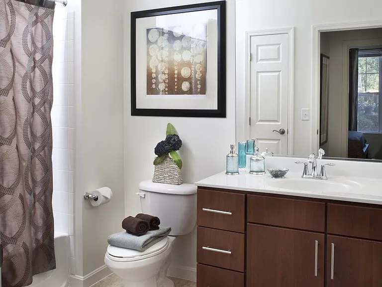 Classic Package II bath with dark oak cabinetry, white laminate countertops, and hard surface flooring
