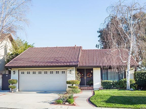 Immaculate home with tile roof and trim landscapin