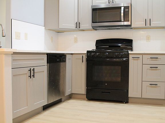 Fully remodeled 9/15/2025 -Modern kitchen with fridge, stove/oven, and microwave.