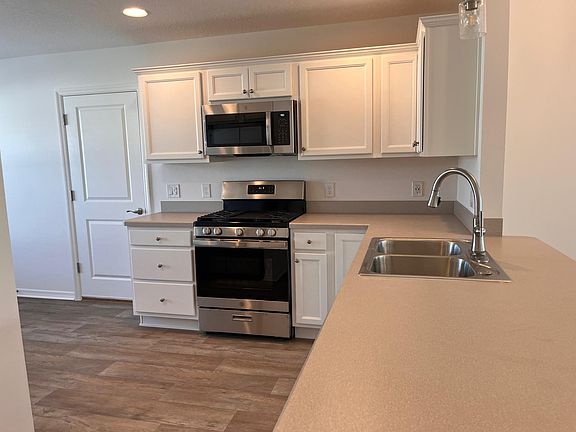 Kitchen has 4 burner gas stove, microwave, fridge, double sink, disposal. Opens to dining area also sundrenched breakfast nook to the left at the front of house.