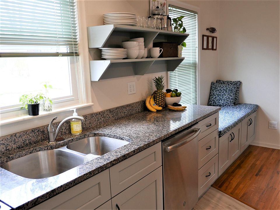 Updated kitchen with granite countertops, soft-close cabinets and drawers, newer appliances: dishwasher, stove, and refrigerator..