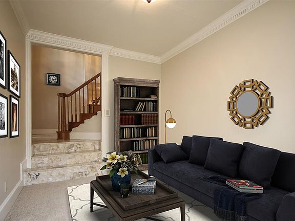 The virtually staged formal living room has a double window for natural light and crown molding. This room could also be used as a music room as it was by the current owners, or even as a 2nd study or reading room. The floor plan is flexible for virt