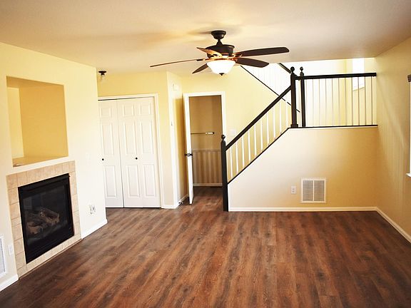 Living room of a very open floor plan. Built in entertainment nook above gas fireplace.