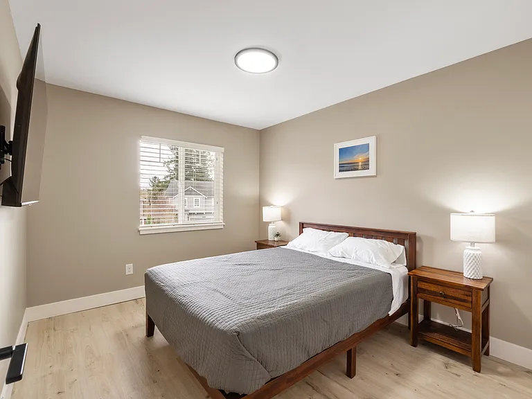 Queen bed with 55" wall mounted Smart TV