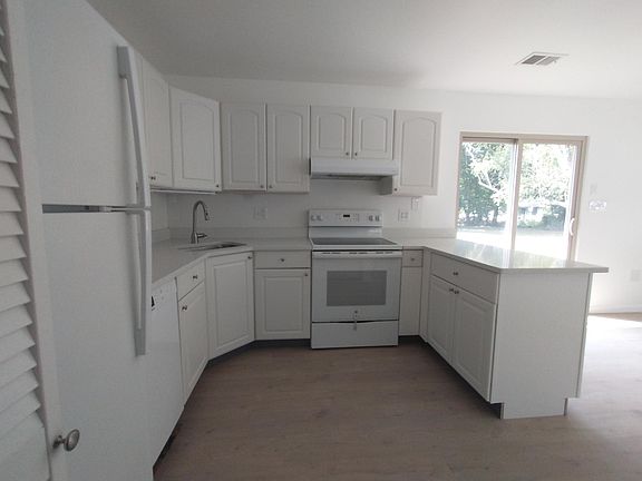 Kitchen from Laundry & Pantry. Sliding door leads to steps to rear patio.