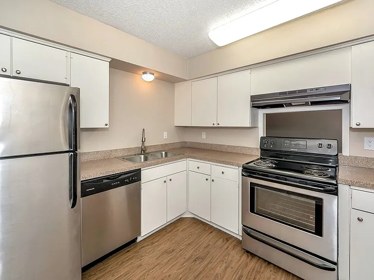 Fully equipped kitchen with modern appliances and cabinet storage