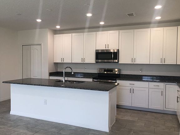 Granite counter top, Ceramic Tile all except bedrooms, stain