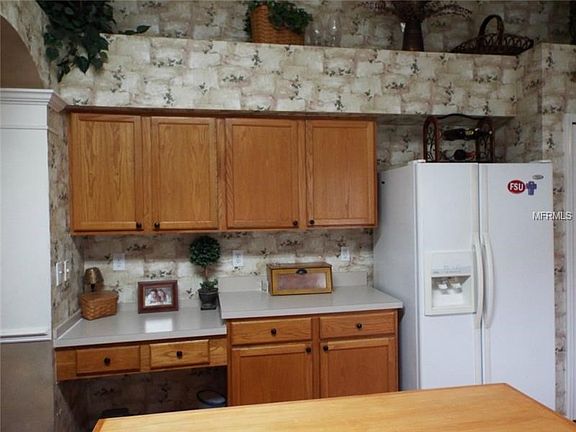 Plentiful of cabinets space, built in desk and decorative plant
