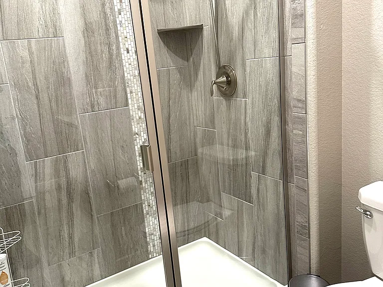 A beautiful, spacious shower and toilet area adds to the bathroom's comfort and appeal, offering both style and functionality.
