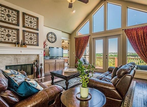 Big open living has wood floors, vaulted ceiling, fireplace and a view!