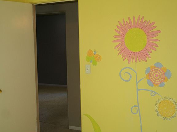 Professionally painted whimscal flower and bug mural