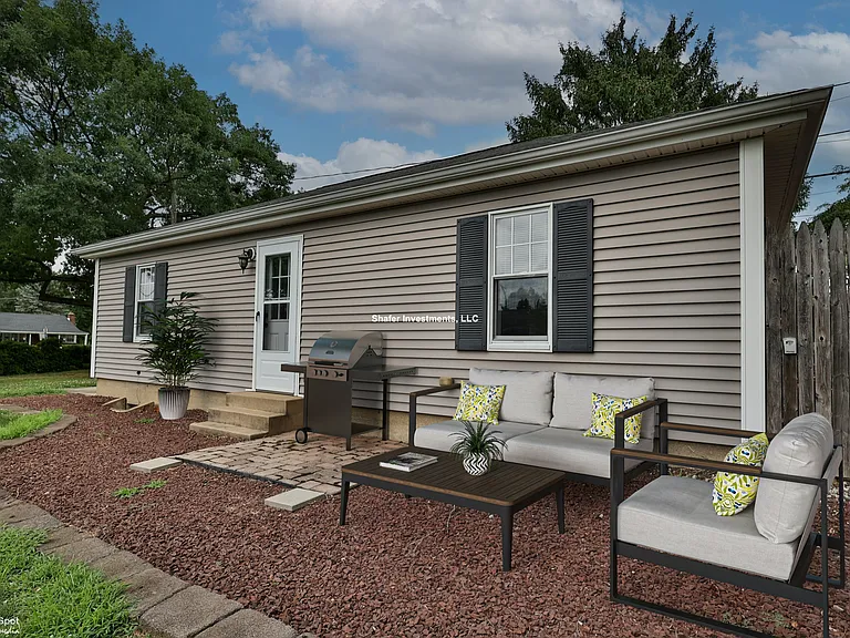 Virtually staged view of the side door and patio