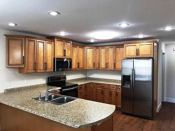 Plenty of cabinets, composite granite look countertops and new appliances.