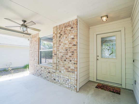 Covered Front Porch with Ceiling Fan and Pull-down Shade.