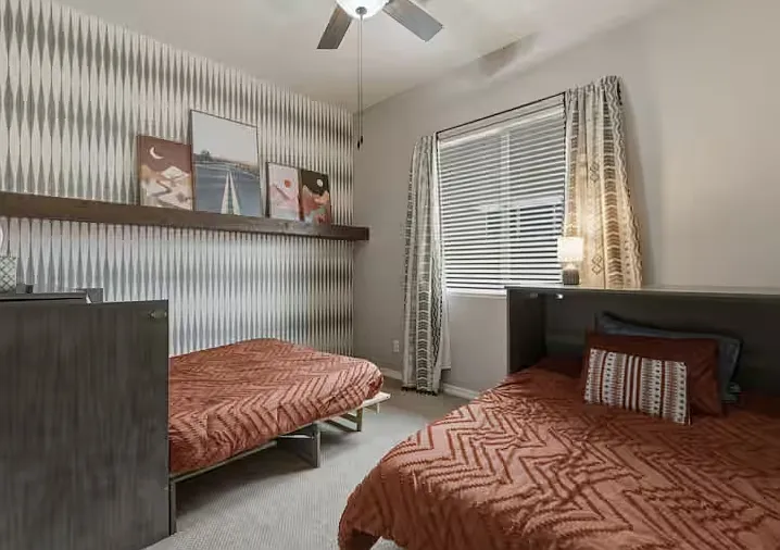 Convertible room with two Murphy dressers that convert into a queen and a full bed. Or the beds can be returned to dressers and used as a playroom.