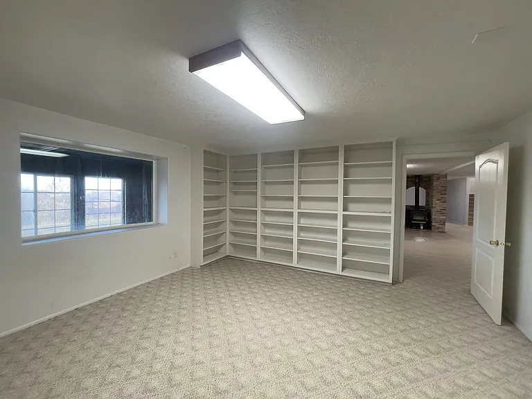 basement office room with built in shelving