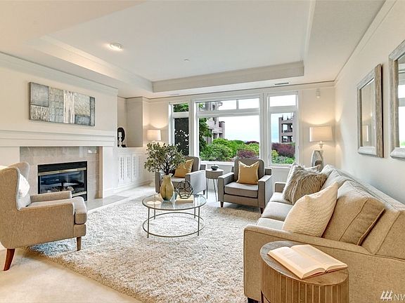 Cozy living room with gas fireplace and marble surround.