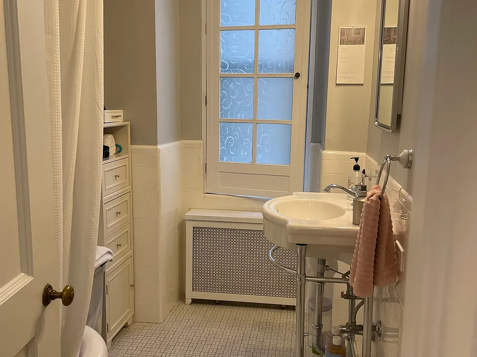 Bathroom with original tile floor and updated fixtures.
