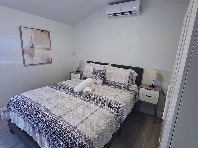 Beautiful bedroom with artwork, bedside lamps, and a spacious closet