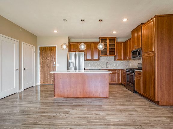 Our premium design packages features premium finishes in the kitchen, including upgraded light fixtures, quartz countertops, custom cabinetry, a gas stove and other upgrade appliances.