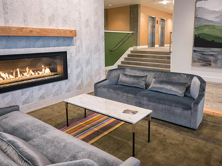 Indoor fireplace with sofas in lobby lounge