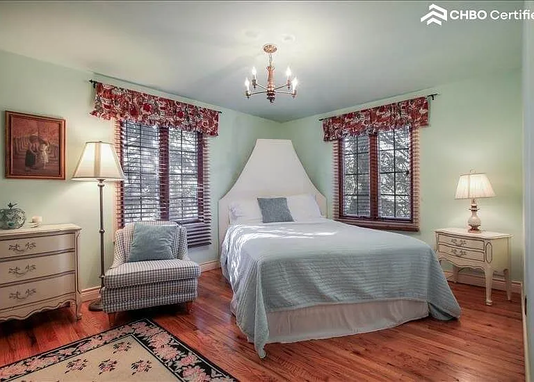 Bed 1-Queen bed, hardwood floors, and blinds.