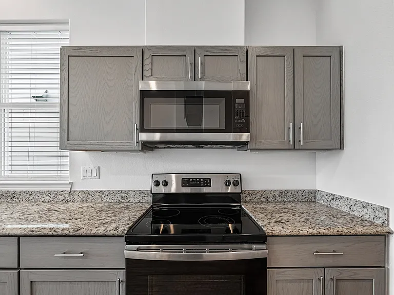 Modern kitchen with granite countertops and soft-close cabinetry.