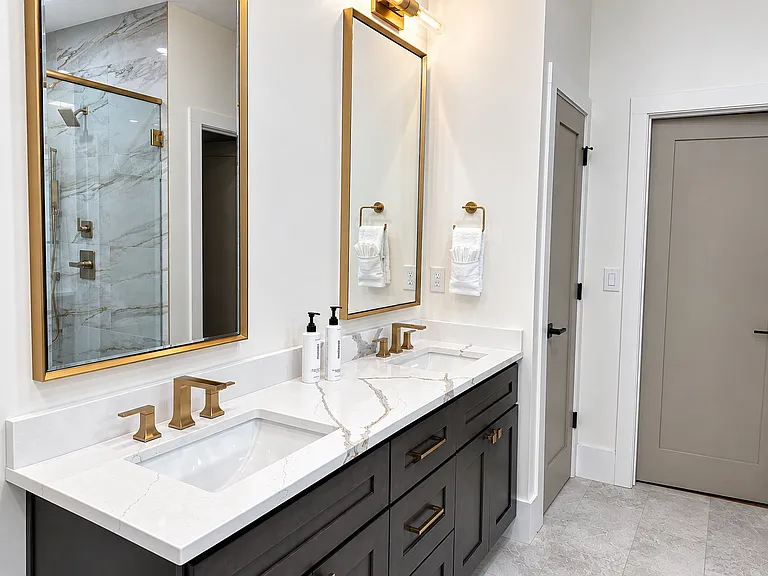 Spa-inspired primary bathroom in the Edgewood Suite featuring luxury, large walk-in shower with rainfall & dual shower heads, plush linens, & premium Apotheke bath products. Designed to help you unwind & indulge in a true boutique hotel experience.