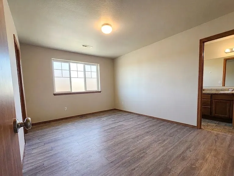 Spacious primary bedroom with walk in closet and en-suite bathroom.