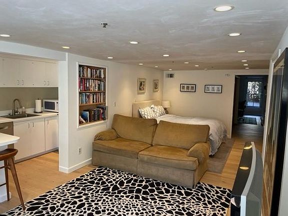 Kitchen to the left and a niche for the bed beyond the living room