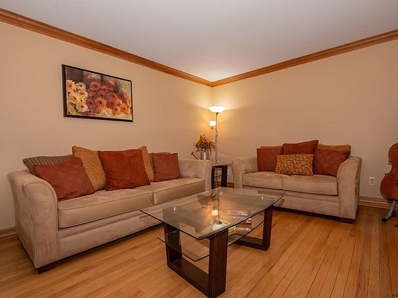 12' x 17'  Hardwood floor, crown molding, neutral decor.