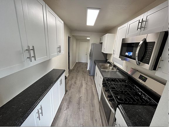 Kitchen looking to back door from living room