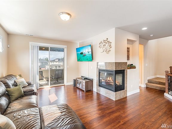 Living room with gas fireplace and covered deck. 