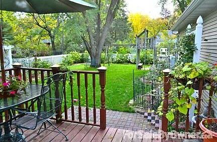 Back yard : Private, Vinyl fenced yard, w hammock, pl. set, sdbox & raised organic beds.