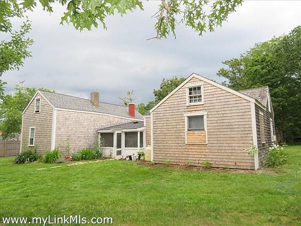 Bedrooms and partial back yard shot. Newly planted grass and re-shingled exterior and roof.