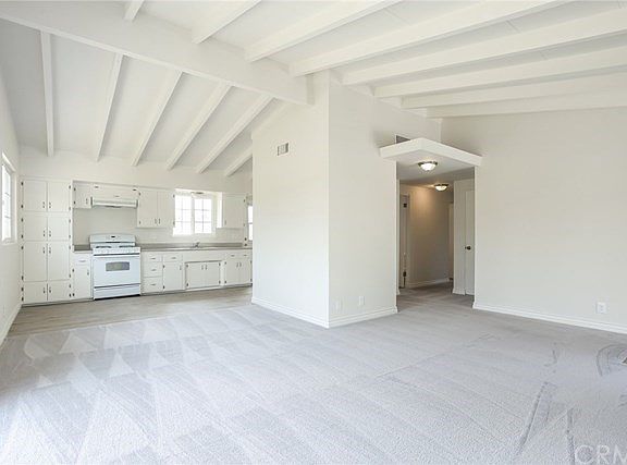 Living room to dining area, kitchen and hallway to bedrooms