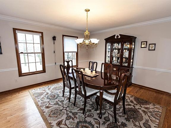 Spacious dining room with hardwood flooring, crown & chair molding.