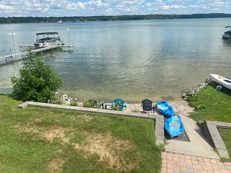 2 tiered seawall with access to the shallow lake via a cement gently sloping ramp makes it easy to slide the kayaks in and out of the lake or to walk into the lake to go for a swim!