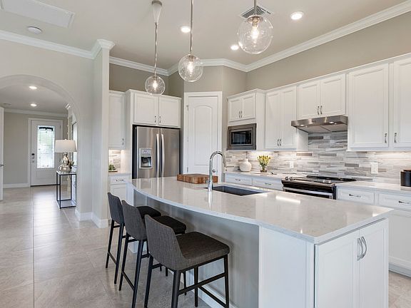 Model Representation Gourmet kitchen with stainless appliances and 42 white cabinets