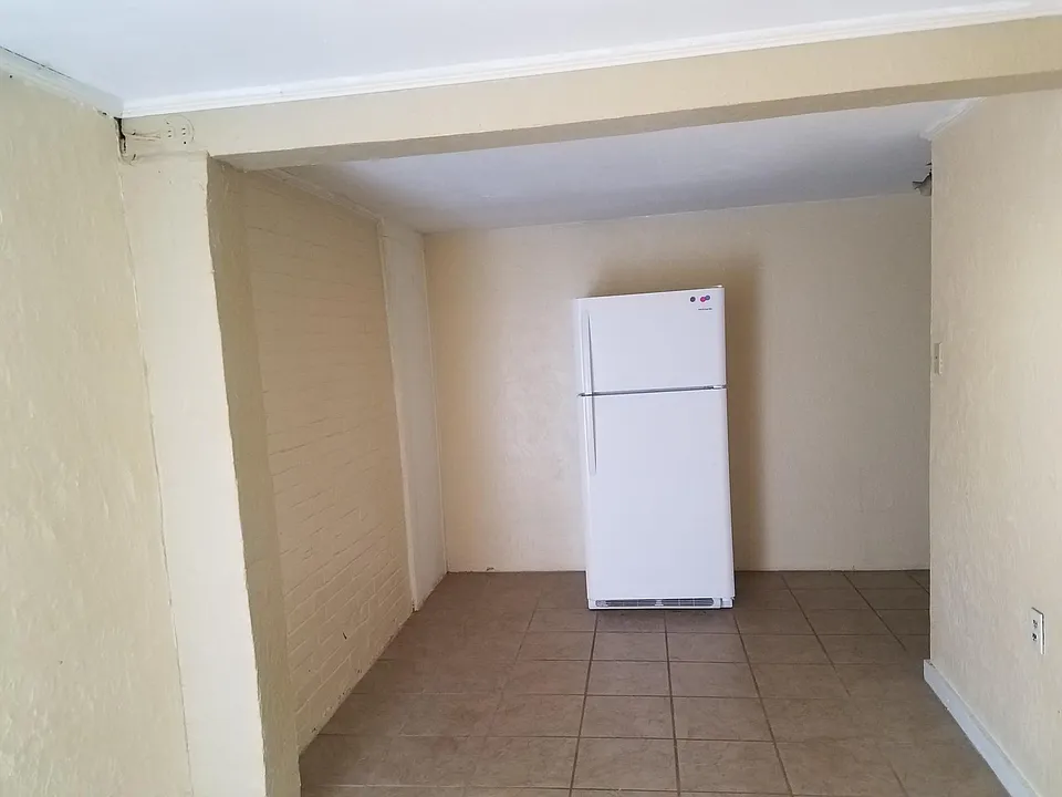 Previous tenants set ice cream table and chairs or other small dining set along left or right wall.
