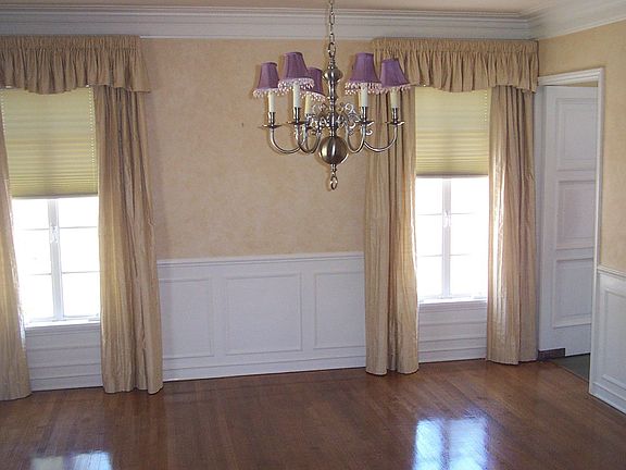 Formal Dining room with custom drapes and hardwood floors