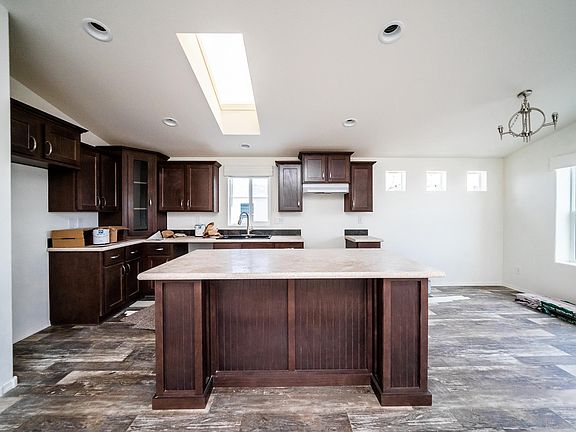 Kitchen - Solid wood cabinets, upgraded nickel hardware, title back splashes, highly upgraded stainless appliance package, center island,  country farm sink with pull out faucet, skylight, recessed lighting.