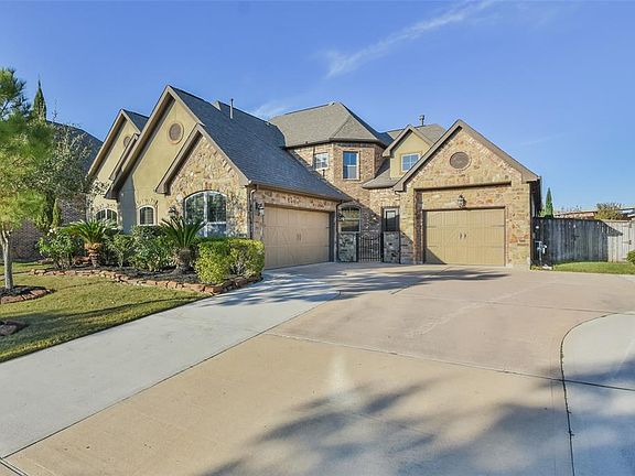 Double-Wide Driveway leading to 2 separate garages! Total of 3 cars can be parked in the Garage!