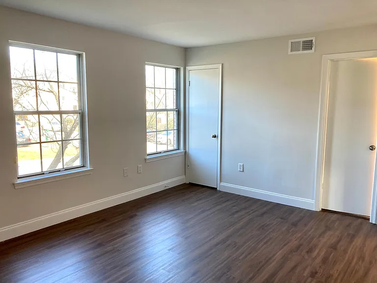 Spacious and well-lit primary bedroom with walk-in closet
