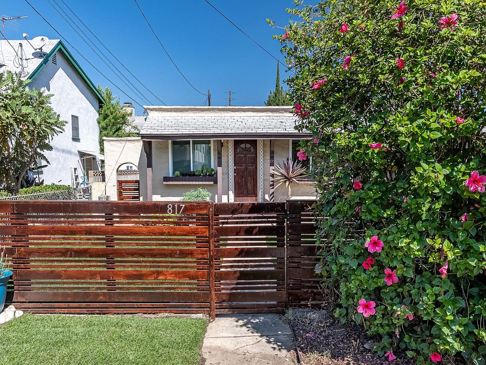 Enclosed front yard with grassy lawn.