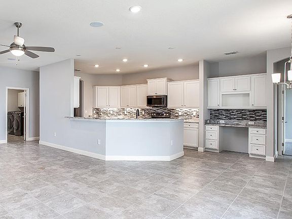 Your new kitchens wows with ample cabinet and counter space, a built-in desk, and your choice of des