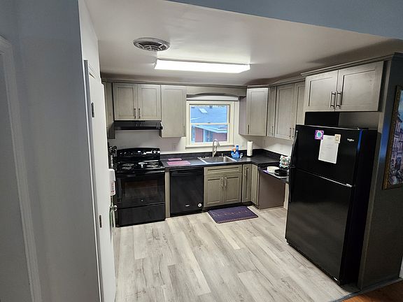 Kitchen with full sized appliances and basic cooking utensils.
