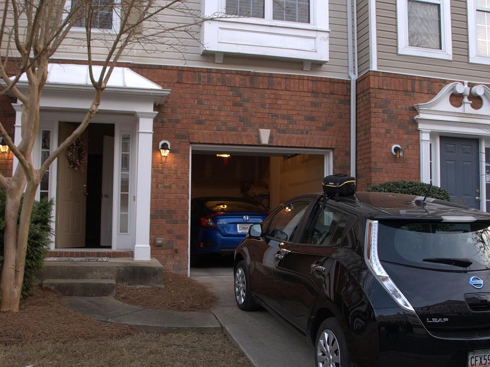 Facade, with entrance, front lawn, driveway, garage, and porch. 1 car garage and driveway for 2nd car. Have guest parking for additional guests